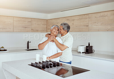 Buy stock photo Hug, love and smile with senior couple in kitchen of home for bonding, retirement or romance. Coffee, morning or security with old man and woman embracing together in apartment for safety or trust