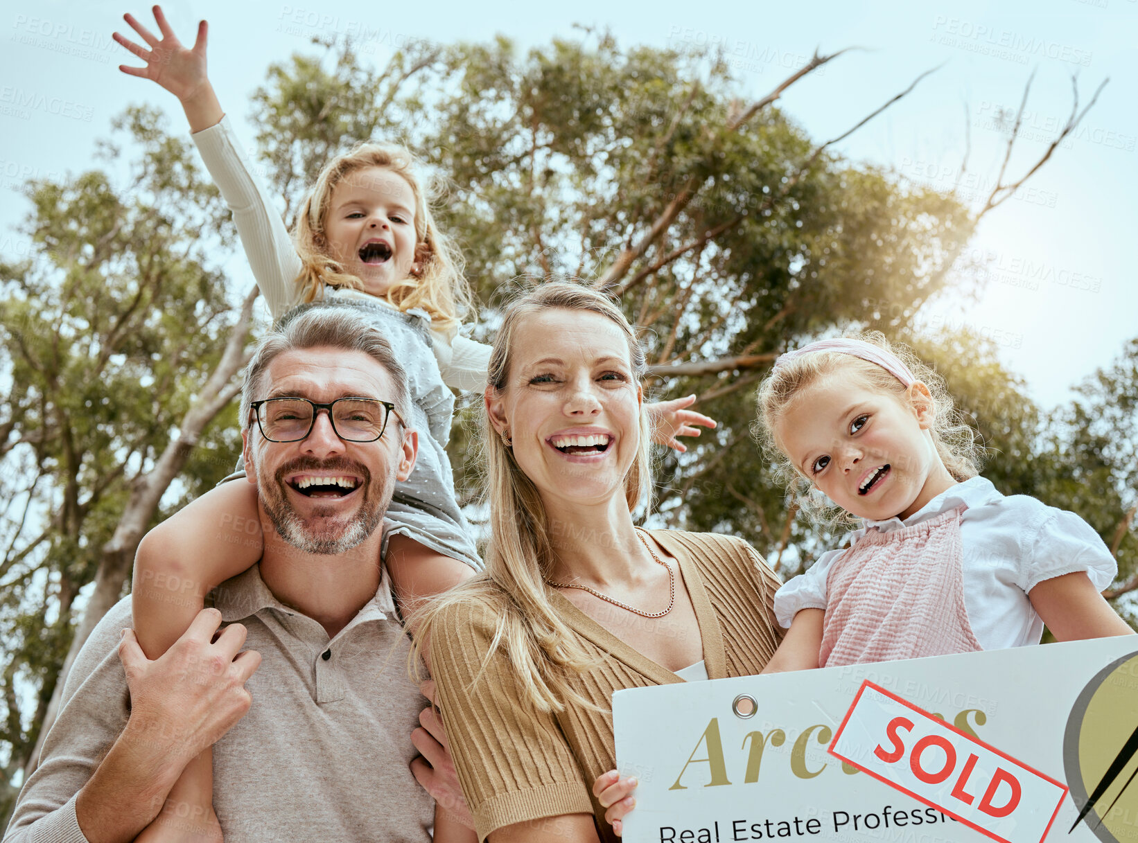 Buy stock photo Family, portrait and sign outdoor for new home, real estate and mortgage loan for investment property. Parents, moving and people with happiness, security and safety for children, growth and future