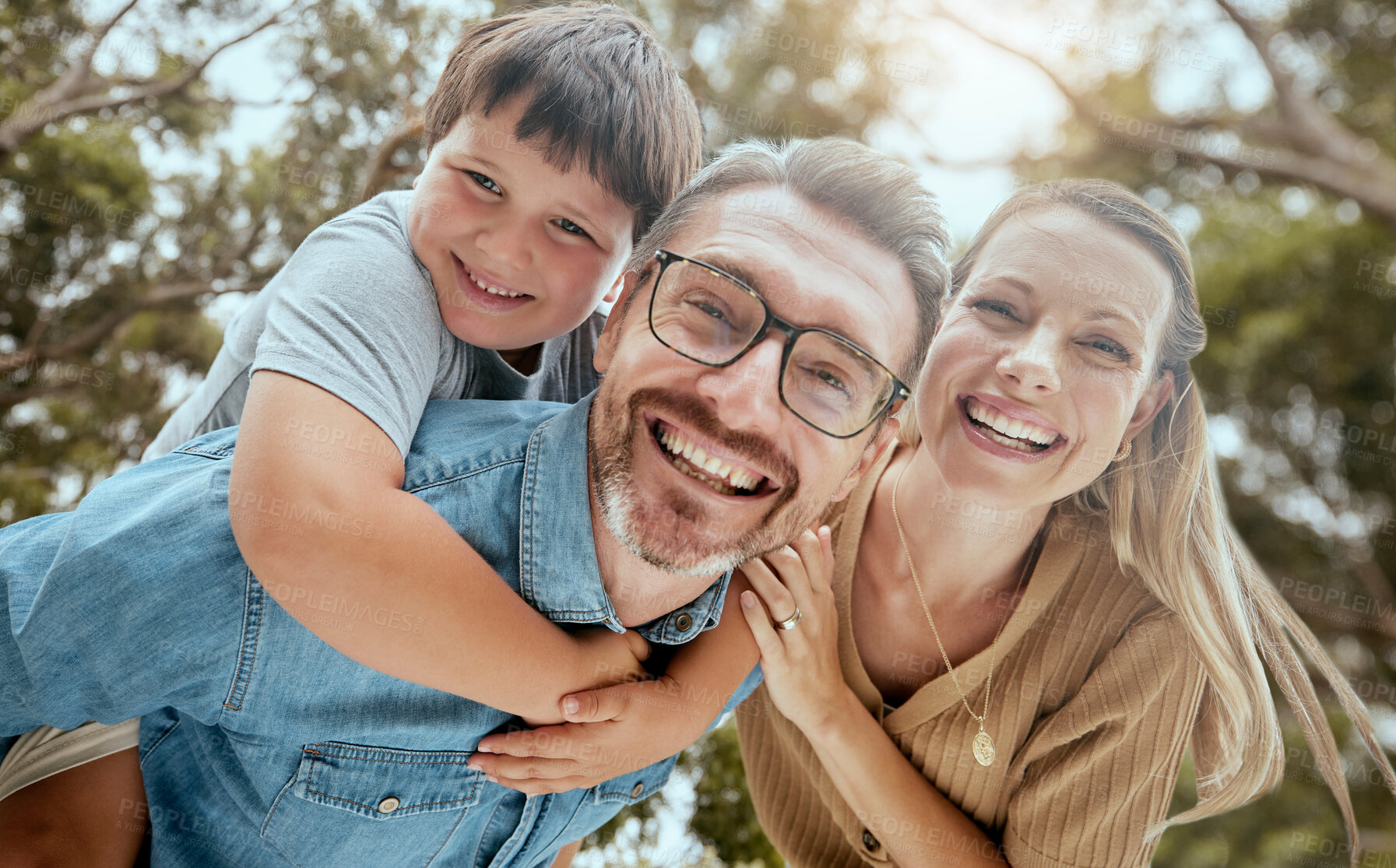 Buy stock photo Portrait, parents and piggyback with children outdoor for playful game, bonding and support of love in backyard. Smile, family and boy with trust, security and care for hug together of development