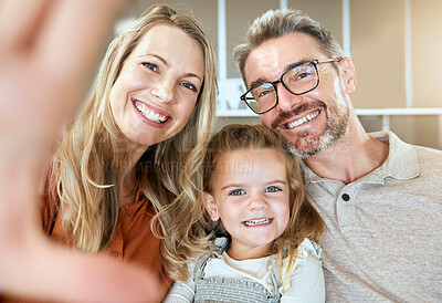 Buy stock photo Selfie, happy mother and portrait of father with kid in home living room for care, love or support. Face, parents and picture of girl for photography, social media or memory of foster family together