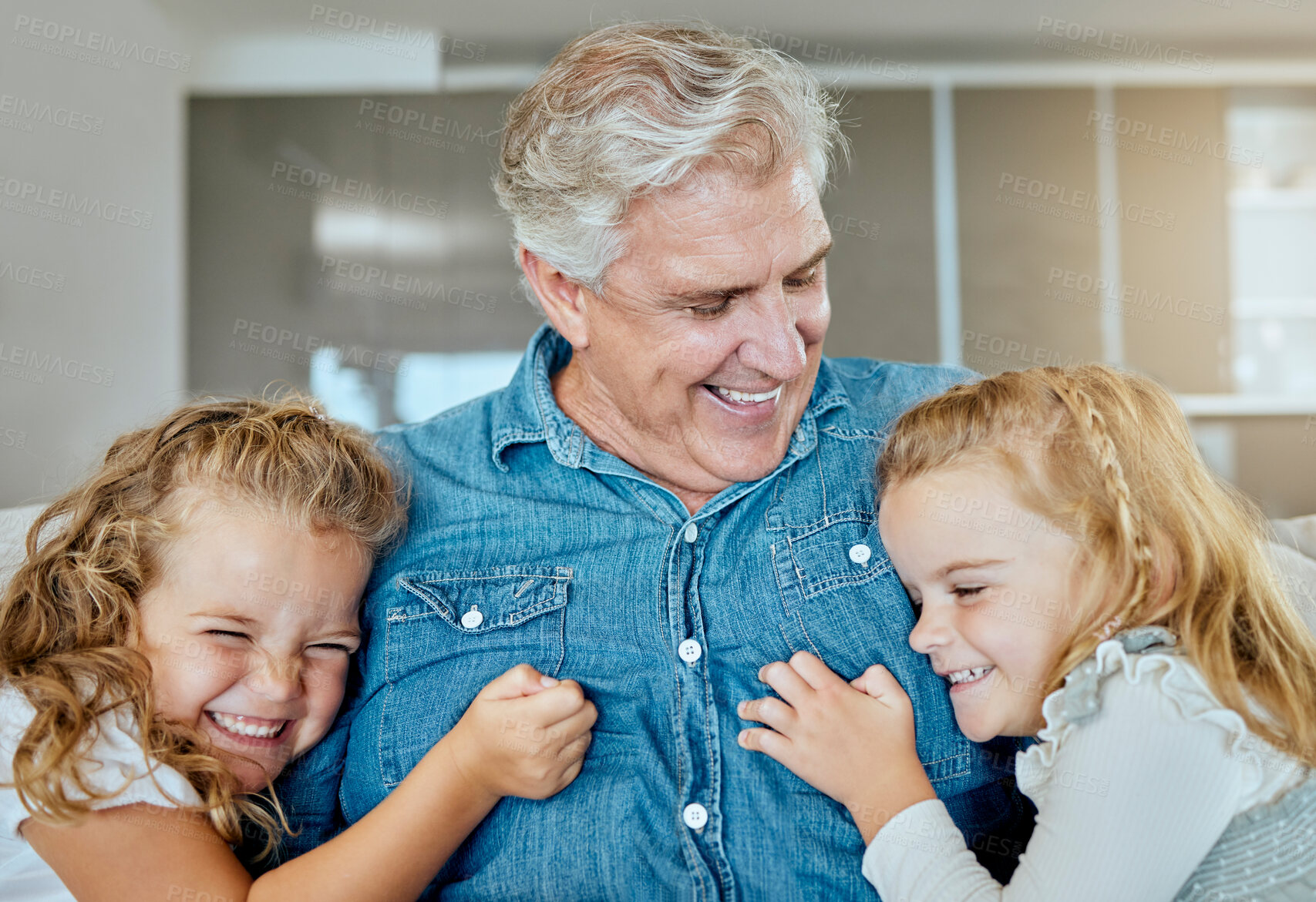 Buy stock photo Happy, grandfather and relax with children at house for family bonding, love and embrace of support together. Excited, senior man and girl with hug for security, trust and comic joke in living room