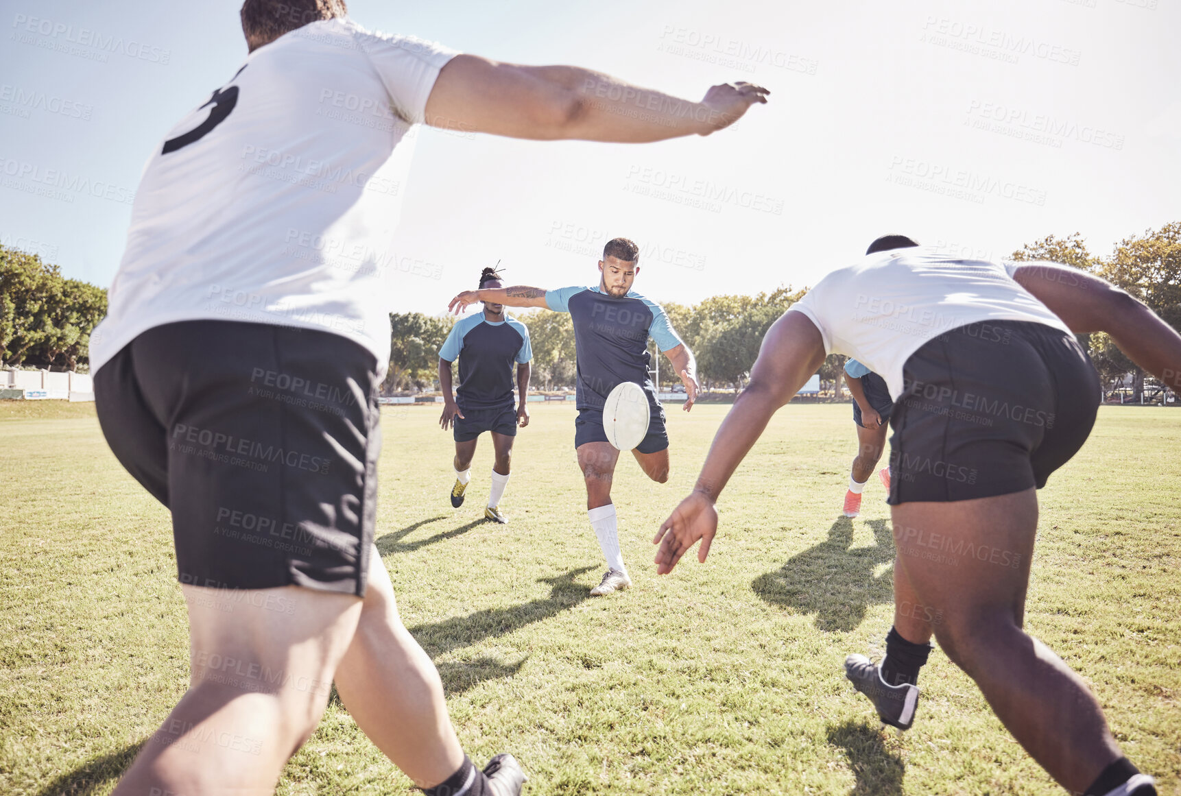 Buy stock photo Sports, drop kick and rugby team on field for training, match or skill development for try. Fitness, defense and player with ball for scoring at practice, game or tournament with opponent at stadium.