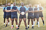 Portrait diverse young rugby players holding a rugby ball while standing with their arms crossed outside on the field. Men looking confident, ready for a match. Athletic sportsmen focused on the game