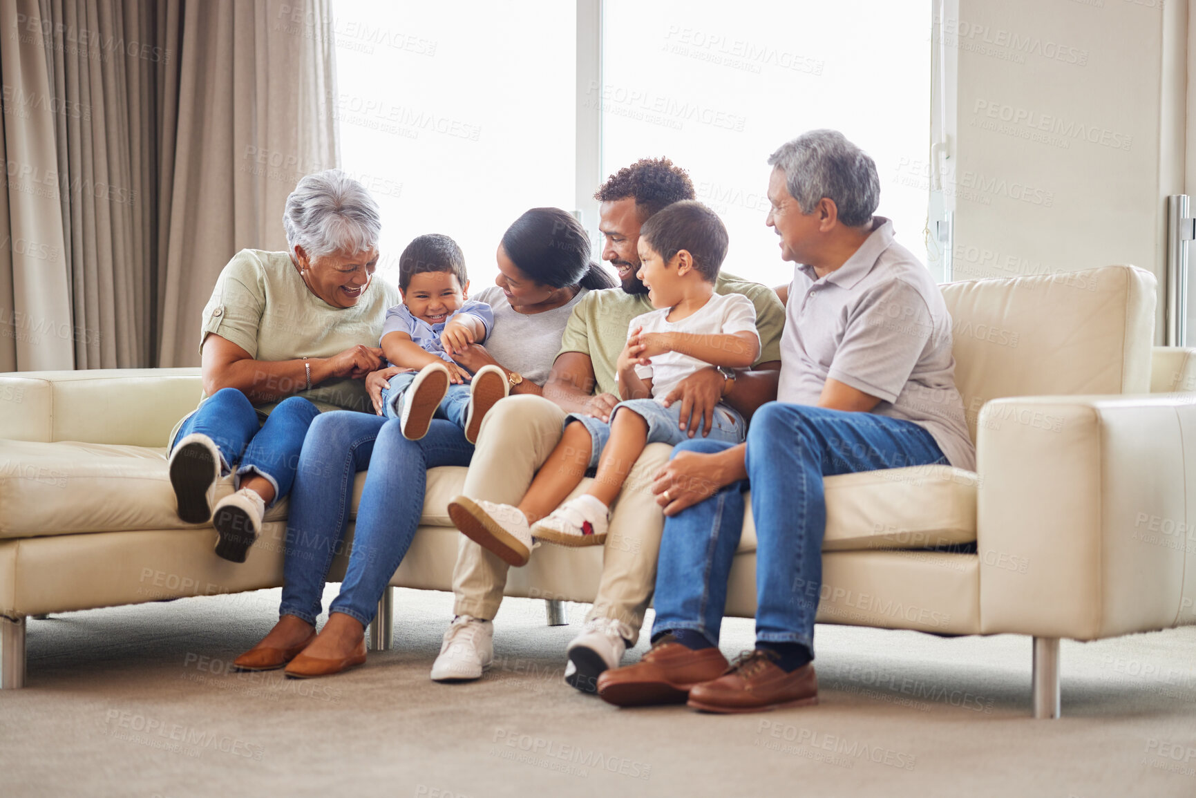 Buy stock photo Grandparents, family and children with home, fun and bonding together in lounge with smile. Care, love and support with generations, happy people and young boys on living room sofa with laugh