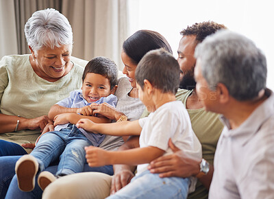 Buy stock photo Grandparents, family and kid smile with home, fun and bonding together in lounge with laughing. Care, love and support with generations, happy people and young boys on living room sofa with tickle