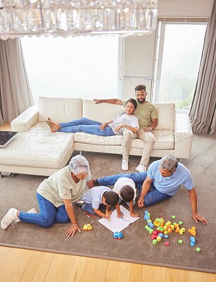 Buy stock photo Big family, children and playing in lounge, grandparents and toys with creativity, fun and happy. Free time, home and people in living room, colouring book, activity and relax with comfort and joy