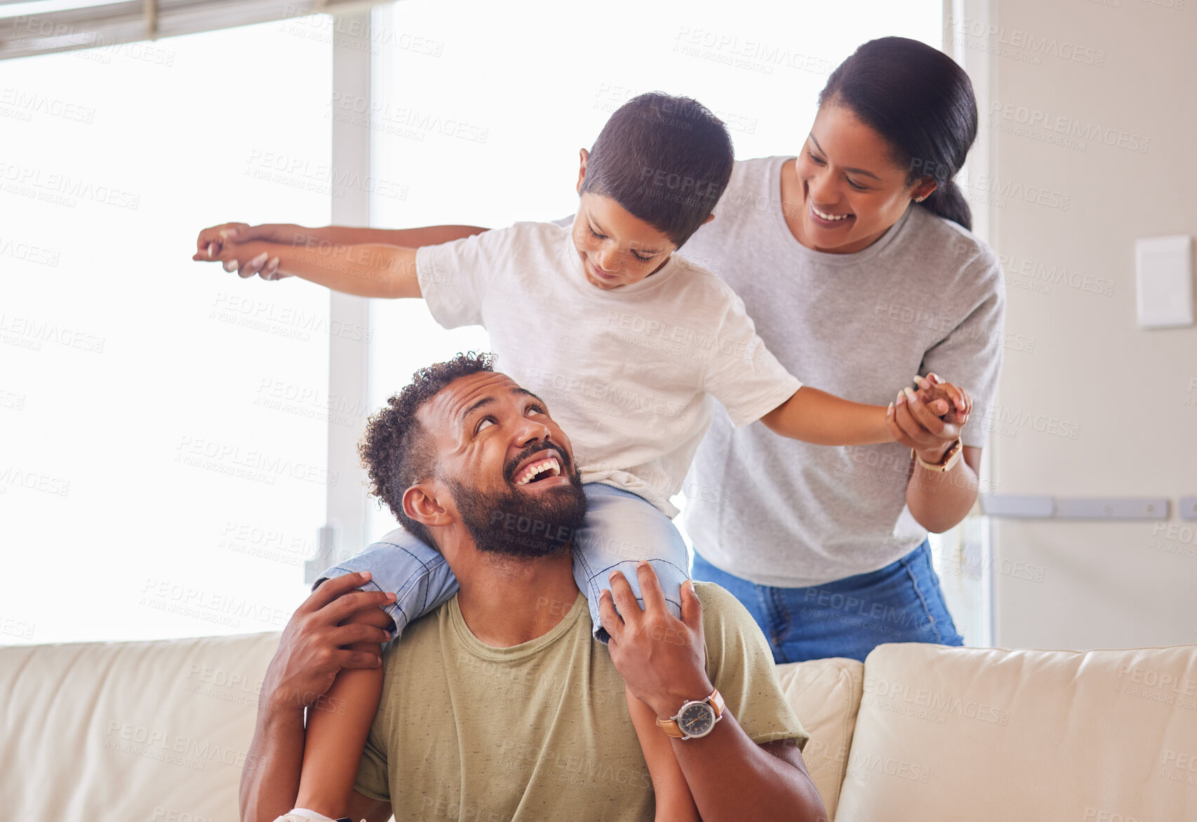 Buy stock photo Plane, shoulders and smile with family on sofa in living room of home together for bonding, fun or love. Balance, energy or fantasy with mother, father and son in apartment for child development