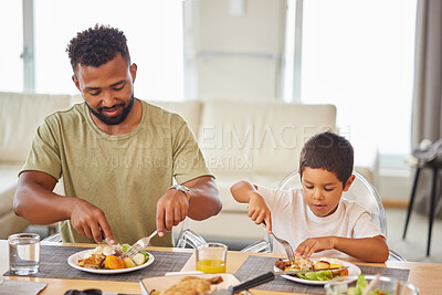 Buy stock photo Dad, kid and eating at table for lunch, healthy food and together in living room. Father, boy child or wellness at home with nutrition, family time or Sunday meal for bonding or childcare development