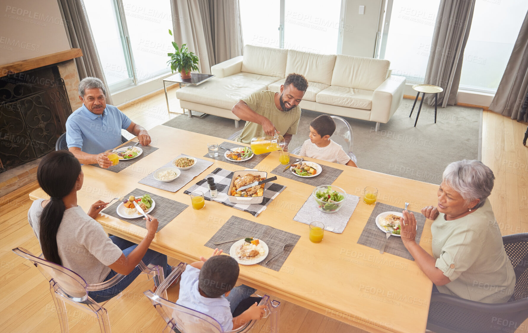 Buy stock photo Family, dinner and eating food at table together for holiday celebration, bonding or sharing meal. People, parents or grandparents with kids in home for lunch, social gathering or talking on top view