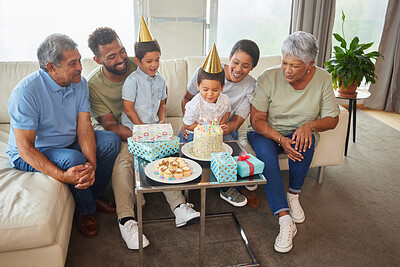 Buy stock photo Family, cake and birthday party in home with relax on sofa for bonding, support and people at fun event. Grandparents, parents and children for growth, celebration and happy with gift in living room