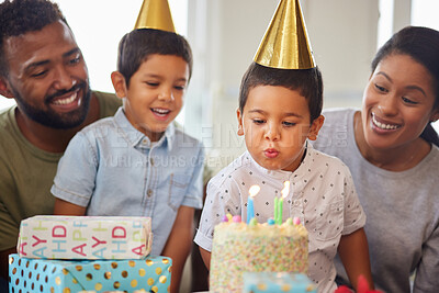 Buy stock photo Birthday cake, family and child blowing candles with happy parents, present and surprise gathering in home. Mom, dad and kids with make a wish for celebration, dessert food and gift for party event