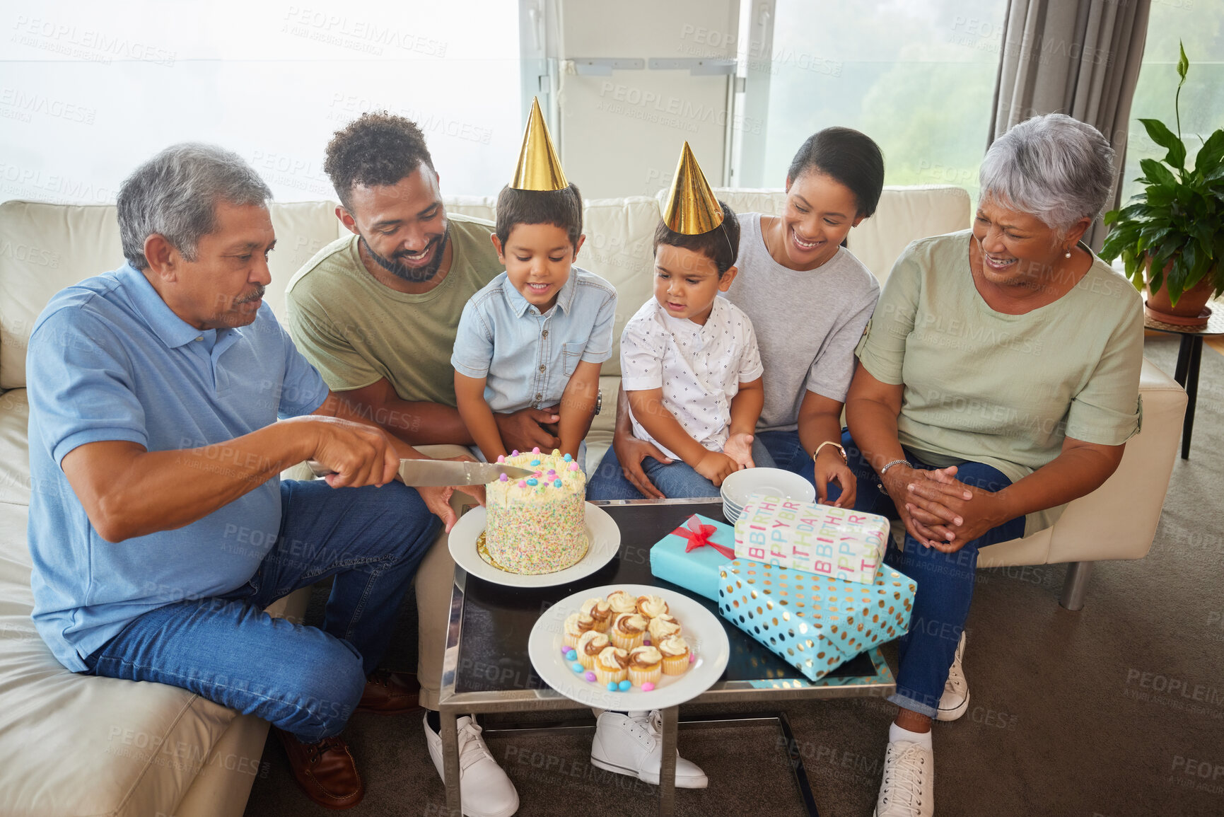 Buy stock photo Family, knife and birthday cake with party on sofa for bonding, support and people at fun home event. Grandparents, parents and children for growth, celebration and happy with gift in living room