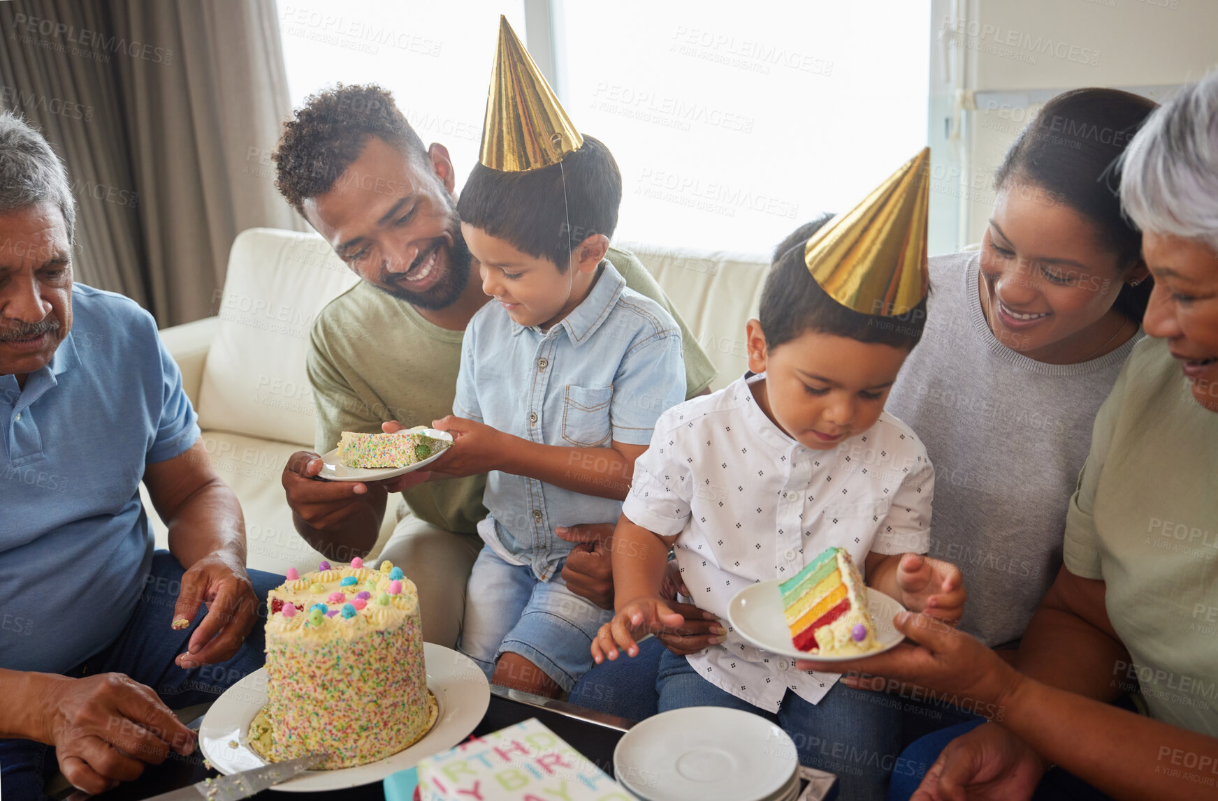 Buy stock photo Family, children and party celebration with cake on sofa for care, bonding and love in living room of home. Happy people, parents and grandparents or kids with sweet dessert, gifts and hats on couch