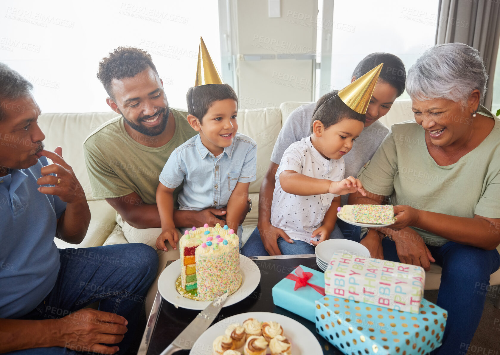 Buy stock photo Family, eating and birthday cake with party on sofa for bonding, support and people at fun home event. Grandparents, parents and children for growth, celebration and happy with gift in living room