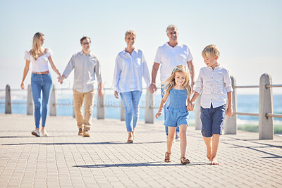 Buy stock photo Family, holding hands and generations for love on beach, promenade and kids for support in outdoor. Parents, grandparents and children for trust on vacation, bonding and holiday for seaside freedom