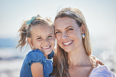 Buy stock photo Mother, happy girl and hug in portrait by ocean, love and beach vacation for support in outdoor. Mommy, daughter and embrace for security in relationship, smile and nature for trust in childhood