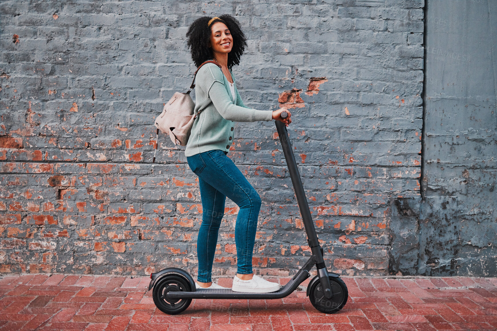 Buy stock photo Black woman, electric and scooter in city with smile, happy and relax for summer day, edgy and trendy on sidewalk. Yong female, girl and eco friendly transportation have fun, cheerful and in street.