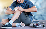 Man, skateboard and knee injury in street, city or outdoors after stunt training accident or failure. Sports, skateboarding and skater with muscle inflammation, leg or knee pain at urban skate park.
