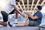 Sports injury, knee and skater man holding wound after accident, falling and fail on skateboard at urban community skate park. Male friends, skating and helping with sore leg during training