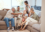 Happy, love and big family relaxing on sofa together in the living room of their house. Happiness, grandparents and parents with children playing, bonding and resting in lounge of their modern home.