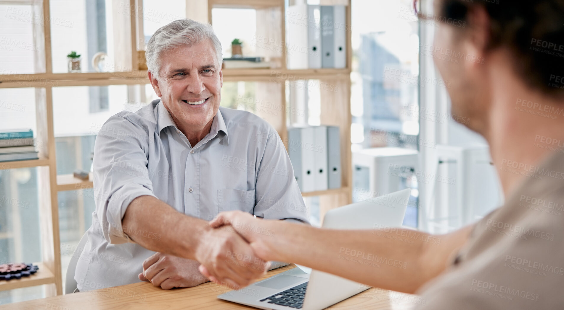 Buy stock photo Senior businessman, handshake and employee in office with laptop, smile or agreement for contract. Ceo, leader or human resources at desk, shaking hands and happy for deal, negotiation or recruitment