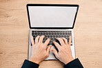 Hands, laptop and typing with green screen above on mockup display for communication, advertising or marketing. Hand of person working on computer for email, advertisement or branding on wooden table