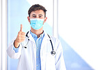 Portrait, doctor and man with thumbs up, mask and success for cure, diagnosis and safety compliance. Face cover, male and medical professional with gesture for ok, emoji and healthcare in hospital