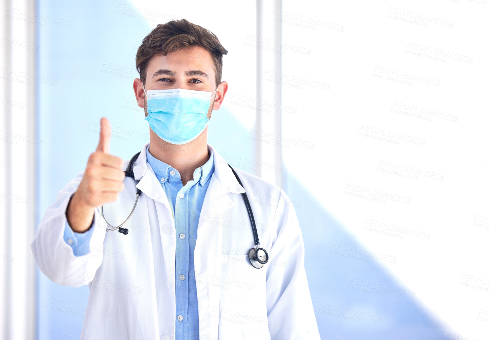 Buy stock photo Portrait, doctor and man with thumbs up, mask and success for cure, diagnosis and safety compliance. Face cover, male and medical professional with gesture for ok, emoji and healthcare with mockup