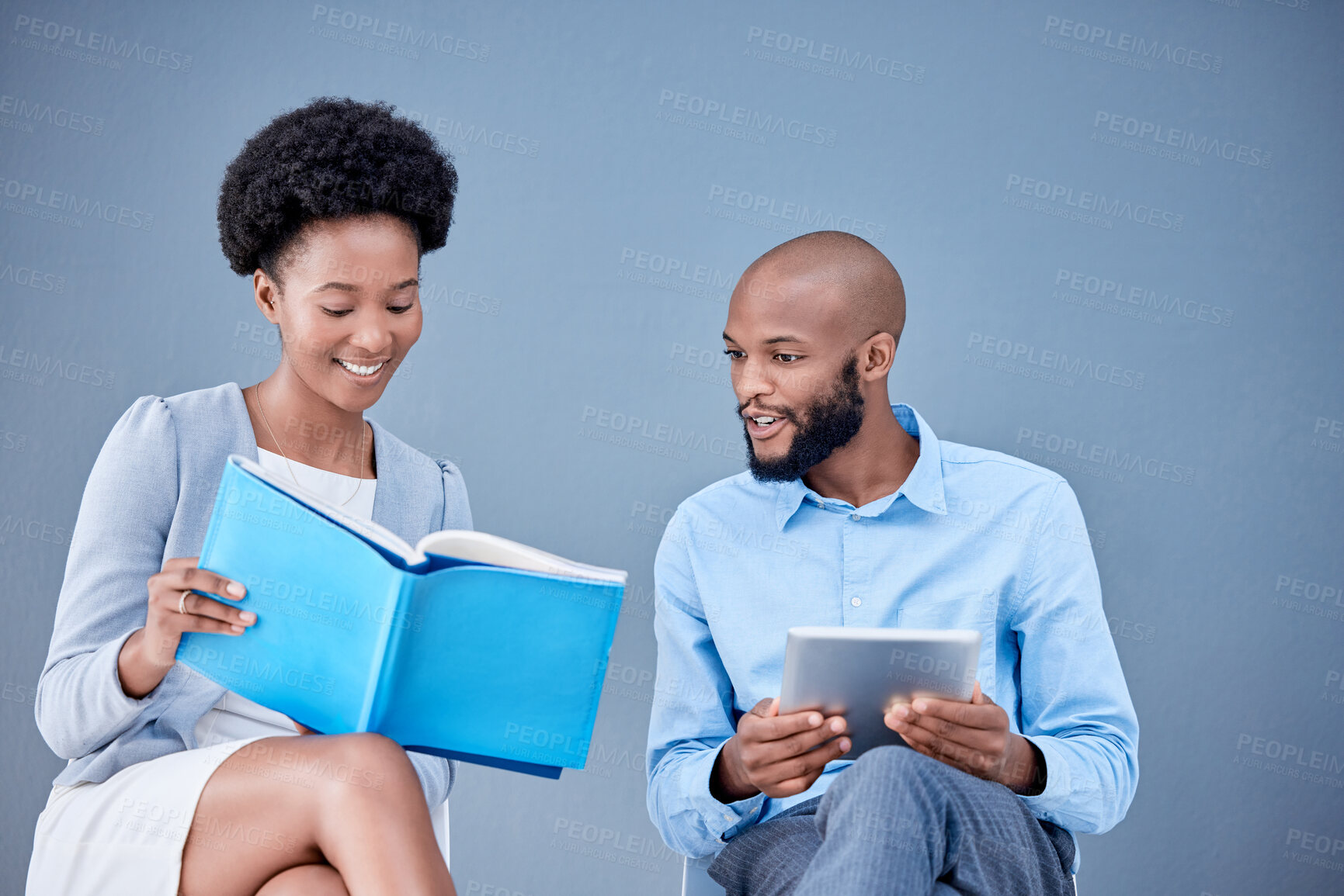 Buy stock photo Black people, business and tablet in research with textbook for information or knowledge against a studio background. Happy African American employee man and woman with touchscreen and reading book