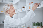 Happy senior woman, pharmacist and inventory on shelf for inspection or checking stock at drugstore. Mature female medical or healthcare professional smile in medication or pharmaceutical at pharmacy