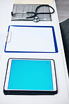 Tablet mockup, screen and hospital desk, healthcare background and documents for medical services. Digital technology, blue space and paperwork with empty clinic for registration, report or charts