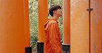 Japanese man, walk and torii gate for religion in shinto culture for thinking, ideas and nature in forest. Person, statue and memory on spiritual journey, Fushimi Inari shrine and faith in Kyoto