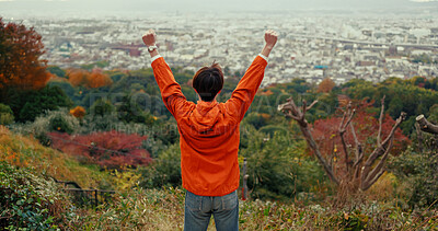 Buy stock photo Man, fist celebration and mountain with view, city and torii gates at Fushimi Inari shrine for shinto religion. Person, hiking and cheers by trees, pillar or achievement on spiritual journey in Kyoto