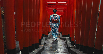 Buy stock photo Woman, shinto religion and walk by gates in japan, spiritual path and indigenous culture in kimono. Person, traditional clothes or worship in peace, respect or beauty by Fushimi Inari Taisha in kyoto