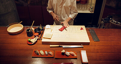 Buy stock photo Hands, cooking and sushi with chef in restaurant for traditional Japanese cuisine closeup from above. Kitchen, seafood dish preparation and person working with gourmet meal recipe ingredients