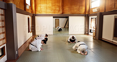 Buy stock photo Aikido class, group and students of martial arts, bow and respect with calm at training, gym dojo. Japanese people, black belt and club for exercise, workout or fitness with fight, conflict or battle