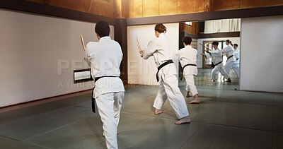 Buy stock photo Aikido group, fight and bokken of martial arts, weapon or black back students at training, gym or dojo. Japanese people, wood sword and club for exercise, workout or fitness in conflict with battle