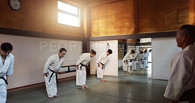 Buy stock photo Japanese students, bow or sensei in dojo to start aikido practice, discipline or self defense education. Black belt master, people learning respect or ready for fighting class, training or aikido