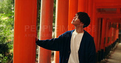 Buy stock photo Thinking, walking and man in Torii gate in Kyoto with peace, mindfulness and travel with spiritual history. Architecture, Japanese culture and person in orange tunnel at Shinto shrine in zen mindset.