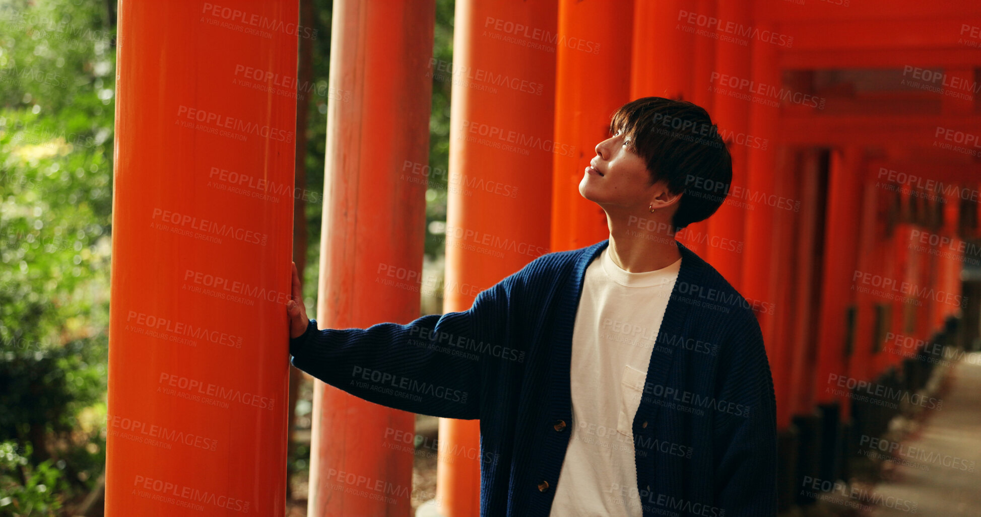 Buy stock photo Thinking, walking and man in Torii gate in Kyoto with peace, mindfulness and travel with spiritual history. Architecture, Japanese culture and person in orange tunnel at Shinto shrine in zen mindset.