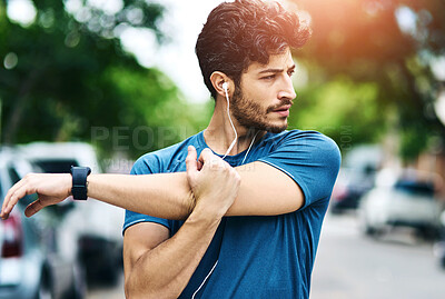 Buy stock photo Man, outside and fitness stretching or arm, muscle preparation and cardio exercise with runner or athlete. Earphones, audio tech and music for streaming motivation, body wellness and morning routine