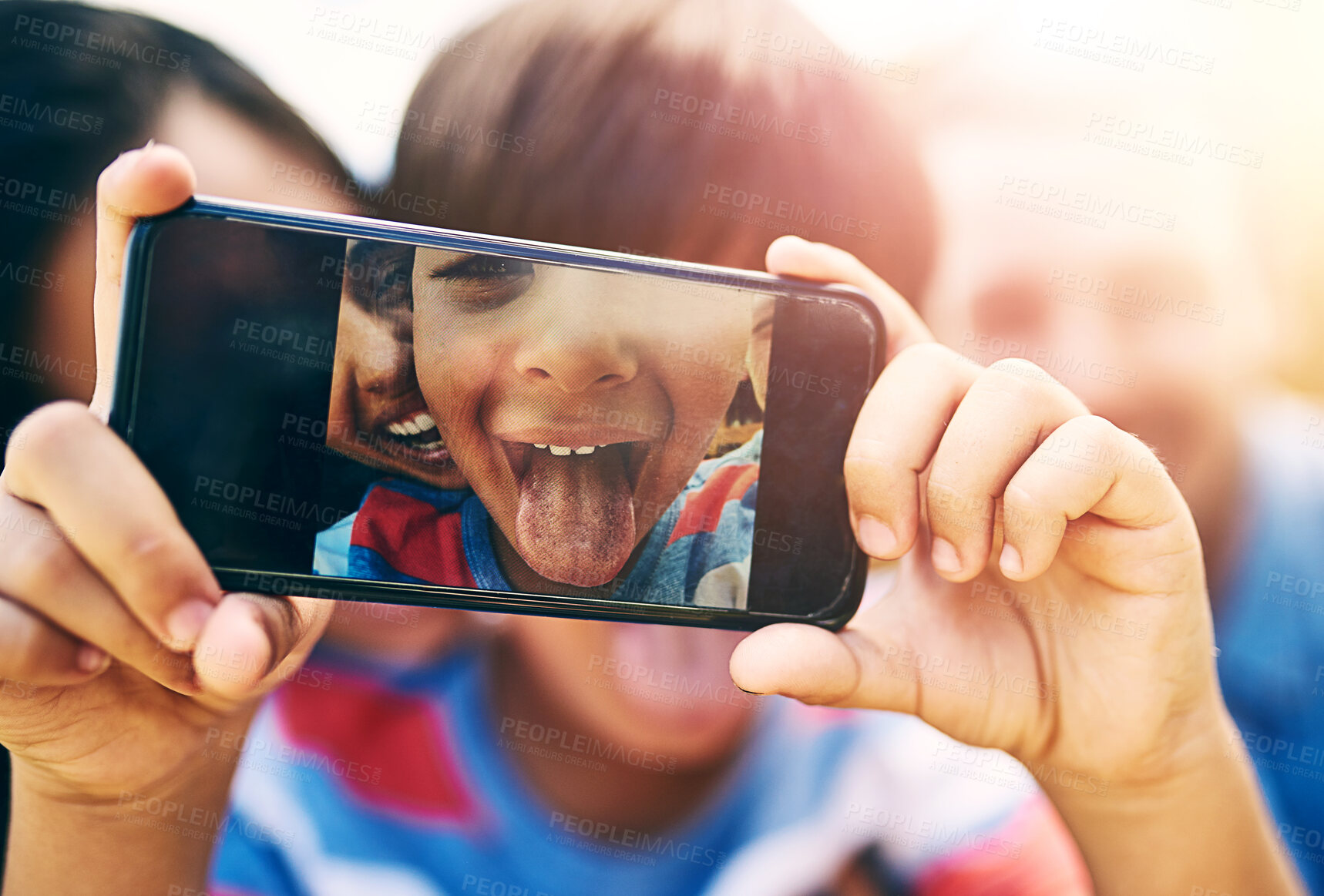 Buy stock photo Phone screen, selfie and tongue of boy with family in garden of home for bonding, fun or memories. Display, funny face or humor with happy mother, father and son in backyard together for social media
