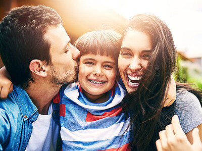 Buy stock photo Mom, child and portrait with dad kiss for love or care, safety and outdoor for bonding with fun. Mother, father and boy kid together for hugging with embrace or security, calm and happy family.