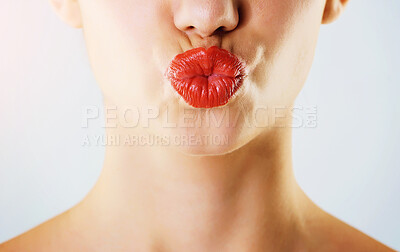 Buy stock photo Lips, pout and red lipstick, studio and closeup of color of makeup, cosmetics and beauty salon for person. Pucker, mouth and model in blue background, aesthetic and ready for kiss, shine and soft