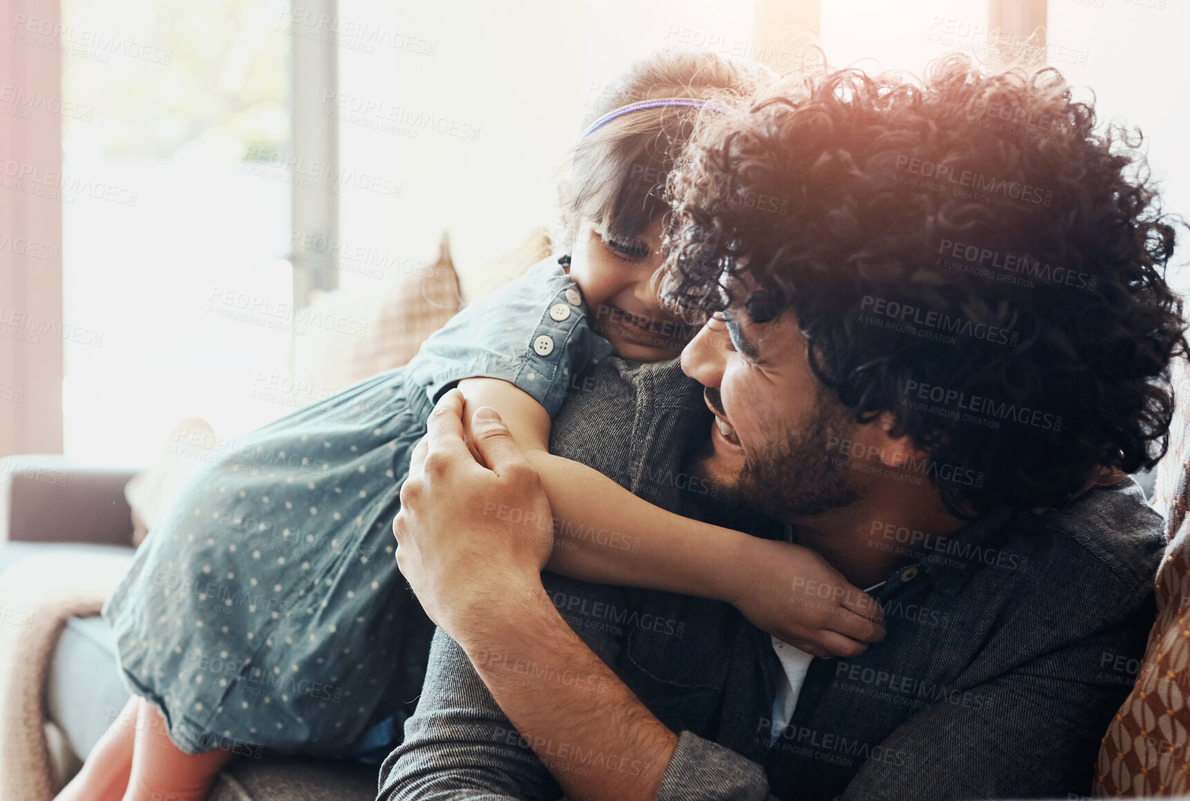 Buy stock photo Happy, dad and girl with hug on sofa for love, gratitude and bonding together in living room. Smile, family and man with embrace of daughter at home for appreciation, trust and support in childhood