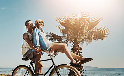 Buy stock photo Happy, ocean and couple on bicycle on holiday, vacation and summer weekend for bonding together. Travel, dating and man and woman cycling on bike for journey, relaxing and fun adventure in Miami