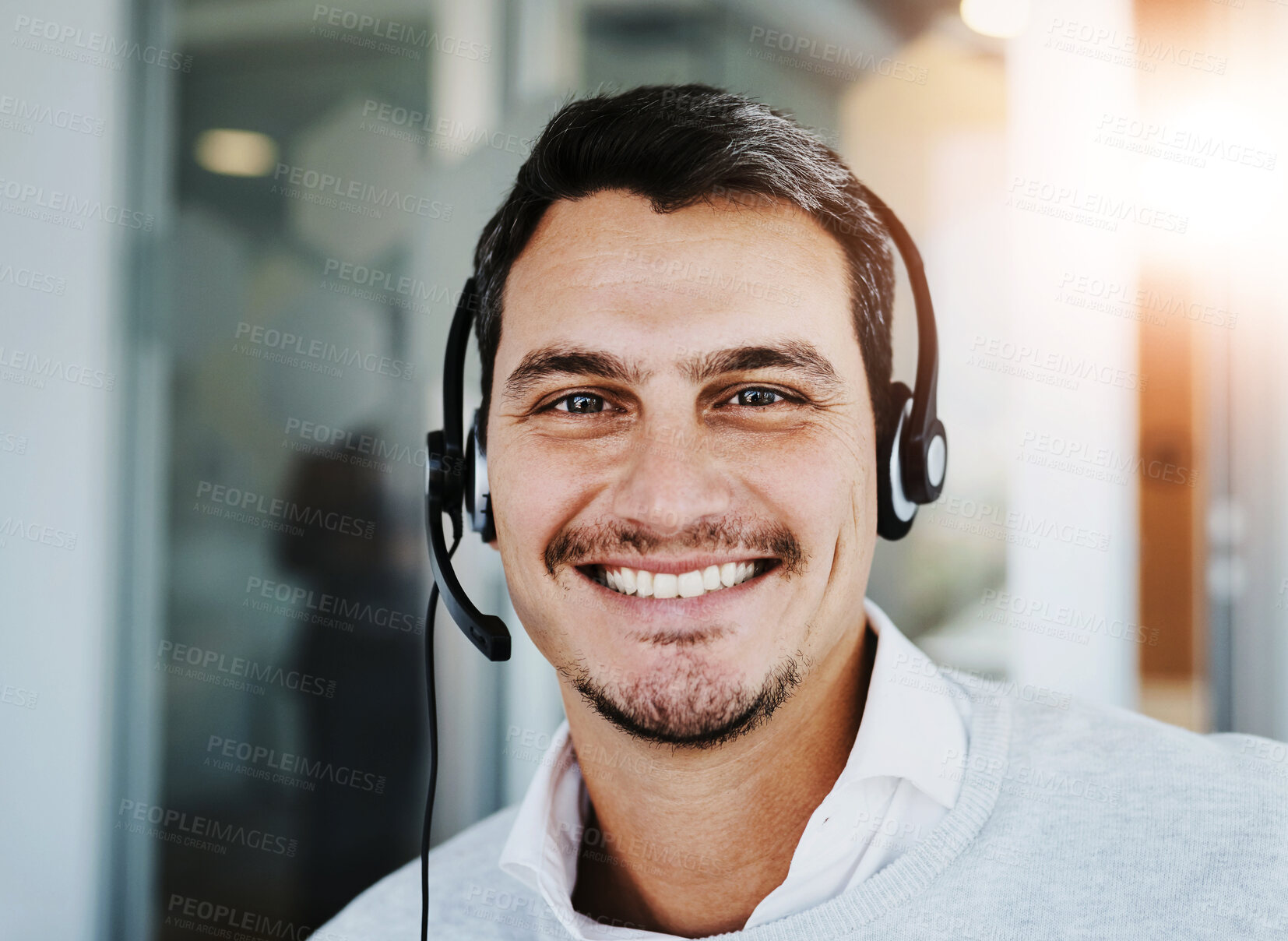 Buy stock photo Call center, portrait and man in office with smile for customer service, technical support or communication. Lens flare, CRM and agent with headset for consultation, help desk or remote assistance