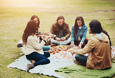 Buy stock photo Group, friends or together in park for picnic with food, university students with diversity in community. People, inclusion or relax in nature for school reunion or connection, outdoor lunch or party