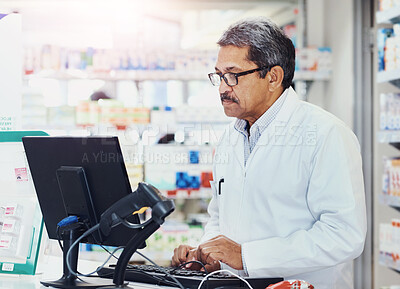 Buy stock photo Mature, man and online with computer in pharmacy for order or inventory management, stock monitoring and research. Pharmacist, technology and checking patient records and prescription processing.