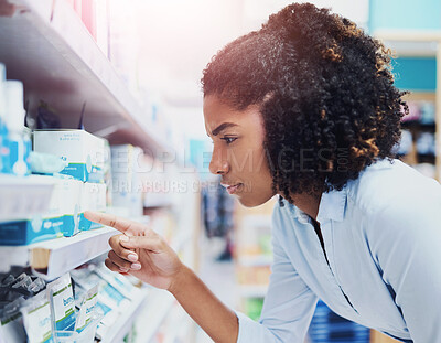 Buy stock photo Pharmacy, decision and woman pointing at shelf to check medical info, choice or price of prescription medicine. Thinking, healthcare and customer reading product label for health benefits of drugs